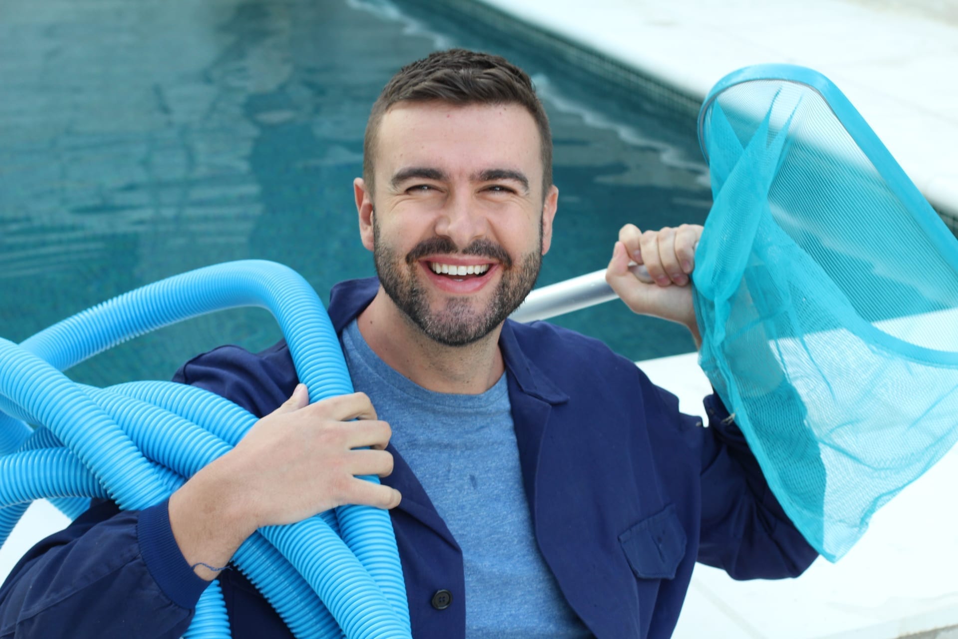 Pool service technician testing water chemistry and logging readings with tablet